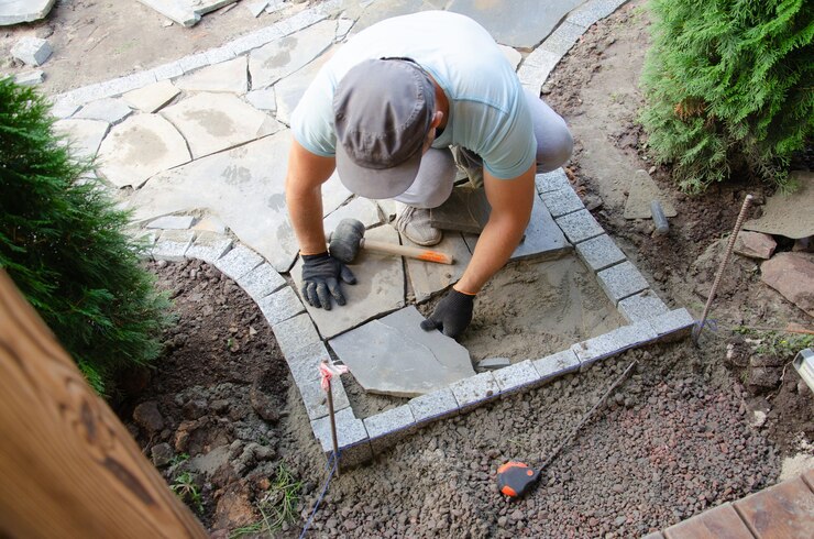 Construction pavement near house bricklayer places concrete paving stone blocks building up sidewalk pavement 140282 298